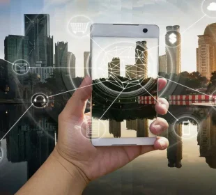 Hand holding a smartphone with a city skyline and glowing connectivity graphics overlaying the scene at sunset/dusk.